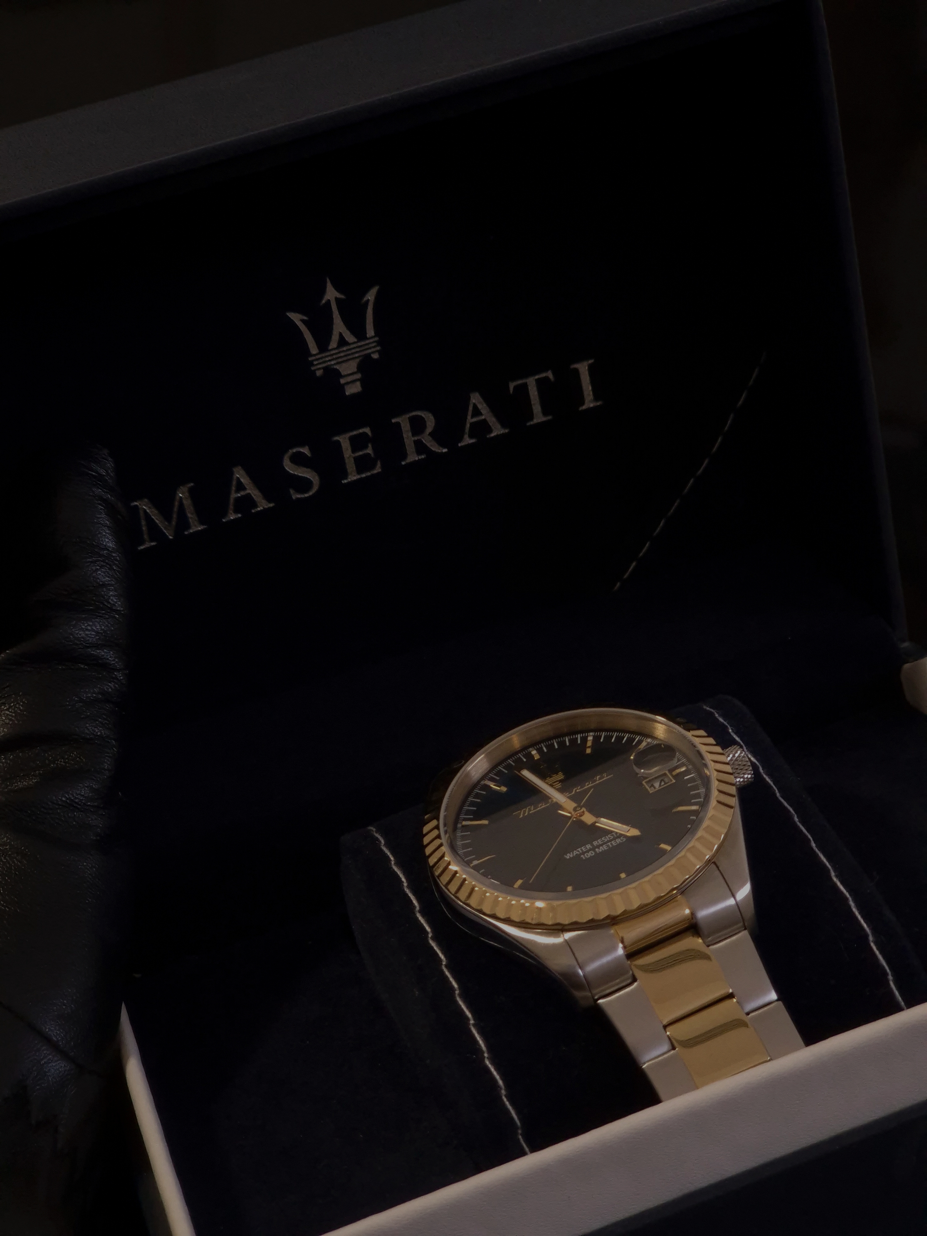 Maserati wristwatch in its presentation box with soft shadows and dark blue interior.