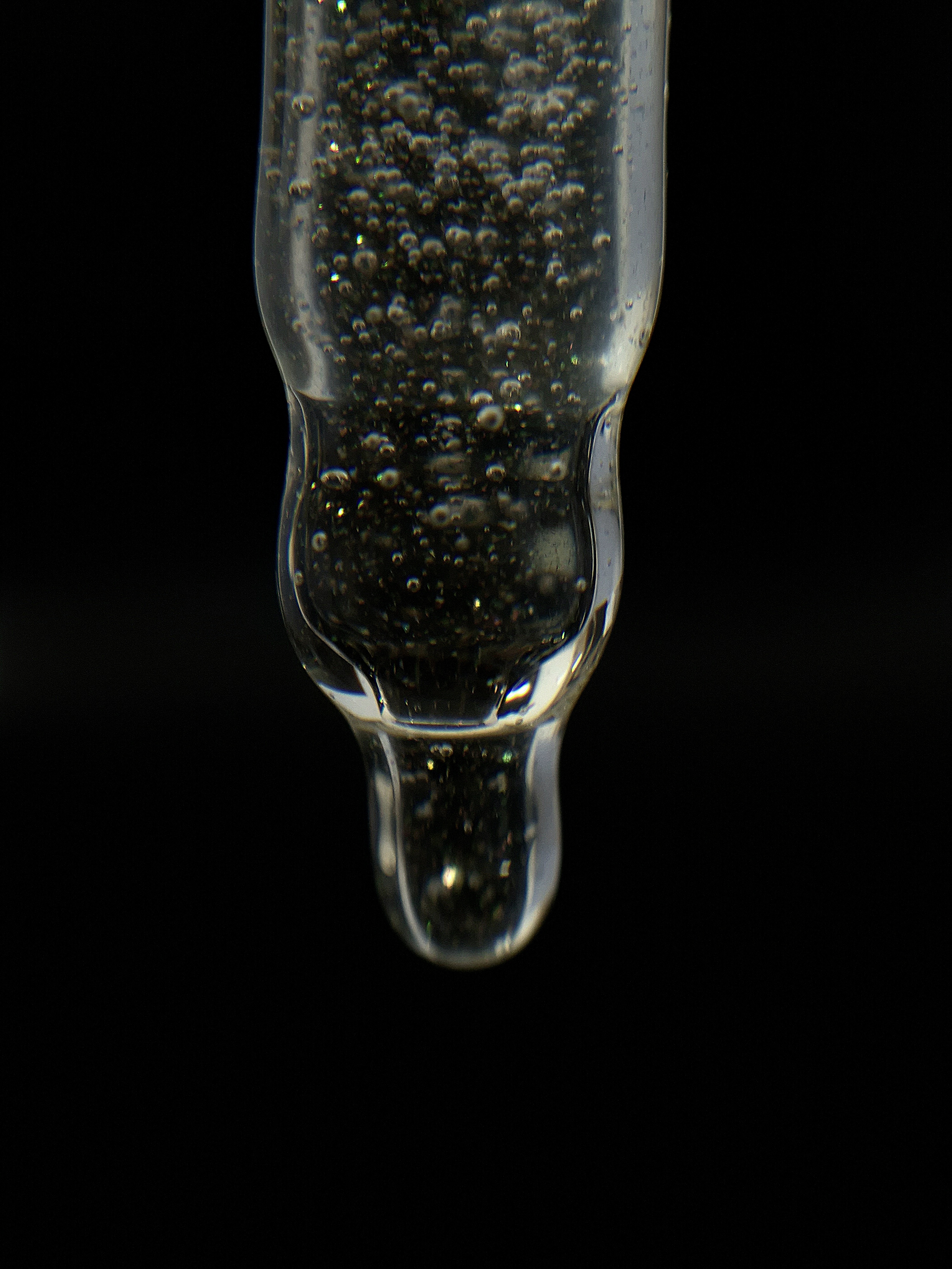Close-up of the dropper tip filled with shimmering bubbles.